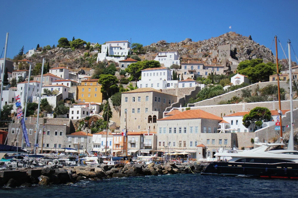 A small harbour town from above — the destination that needs a clear guest count.